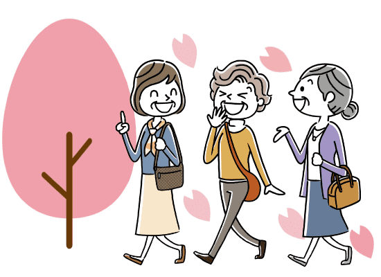 桜の散る道を歩く三人の高齢女性