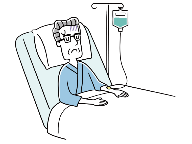 入院して点滴を受けている、顔色の悪い高齢男性