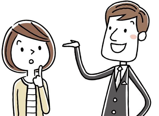 手を差し出して話をするスーツ姿の若い男性と話を聞く若い女性