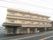 鉄骨造３階建ての建物の様子。やわらかい色合いが印象的な建物