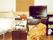 テレビやタンス、ベッドなどいろいろな調度品が写っている写真。部屋の一角の写真