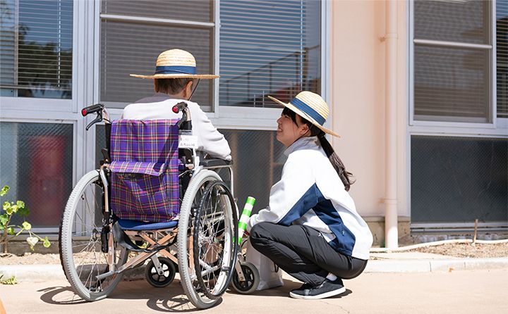 車椅子の方と話すスタッフ