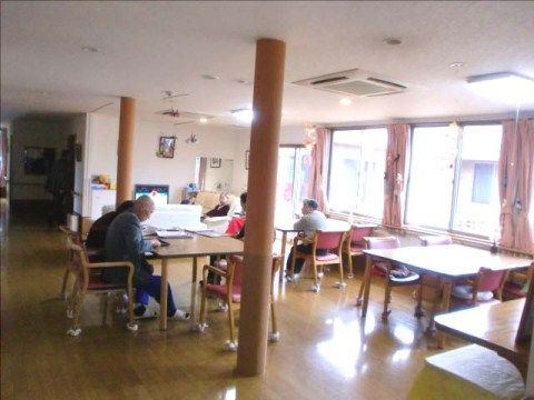 2本の柱と、それぞれに過ごす入居者の方々が見える食堂
