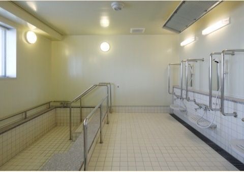 入居者様が安全に入浴できるように、浴室には手すりを多数設置している。段差も少なく、転倒しにくくなっている。