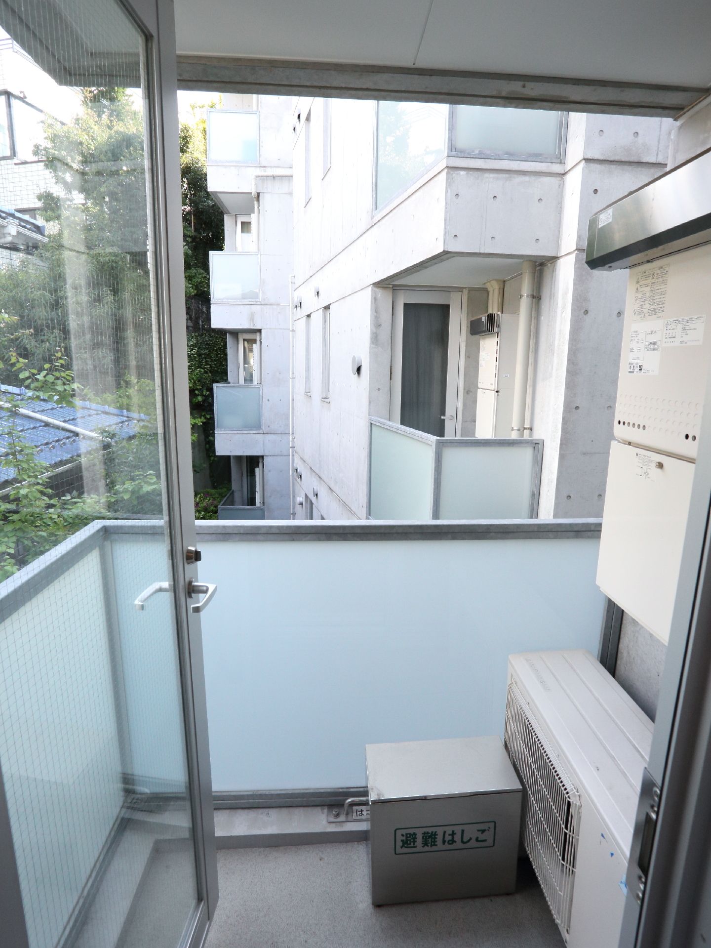 施設内には野外に出られる、小さなベランダが設置されている。室外機があり、避難用のはしごが用意されている。