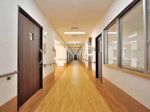廊下はフローリングになっており広々としている。引き戸式の茶色い大きなドアがあり、壁には手すりが付いている。