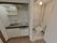 左側の壁には手すりがついており奥にはウオッシュレットトイレが設置されている。右側にはタオルかけやトイレットペーパーもある。