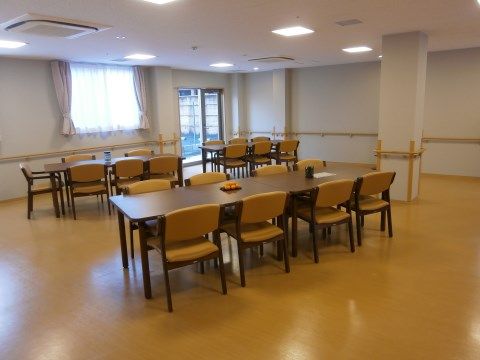 食堂はとても広く、ゆとりをもってテーブルと椅子が並んでいる。食堂の奥には外に出られる出入口が見える。
