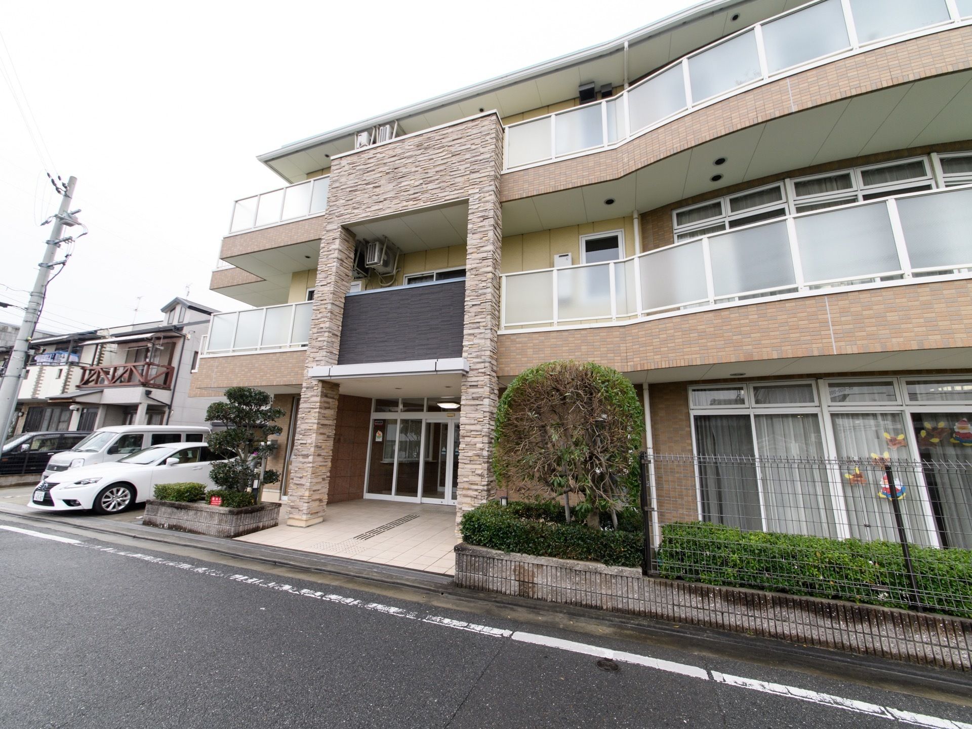 施設は道路に面して建てられている。ライトブラウンを基調とした3階建ての建物である。施設前にはプランターや植木鉢が複数並べられている。