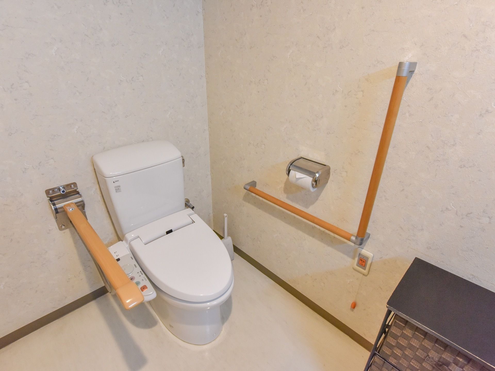 お手洗いには温水洗浄便座のついた、洋式便器を設置している。また壁にはナースコールがあり、可動式の手すりが取り付けられている。
