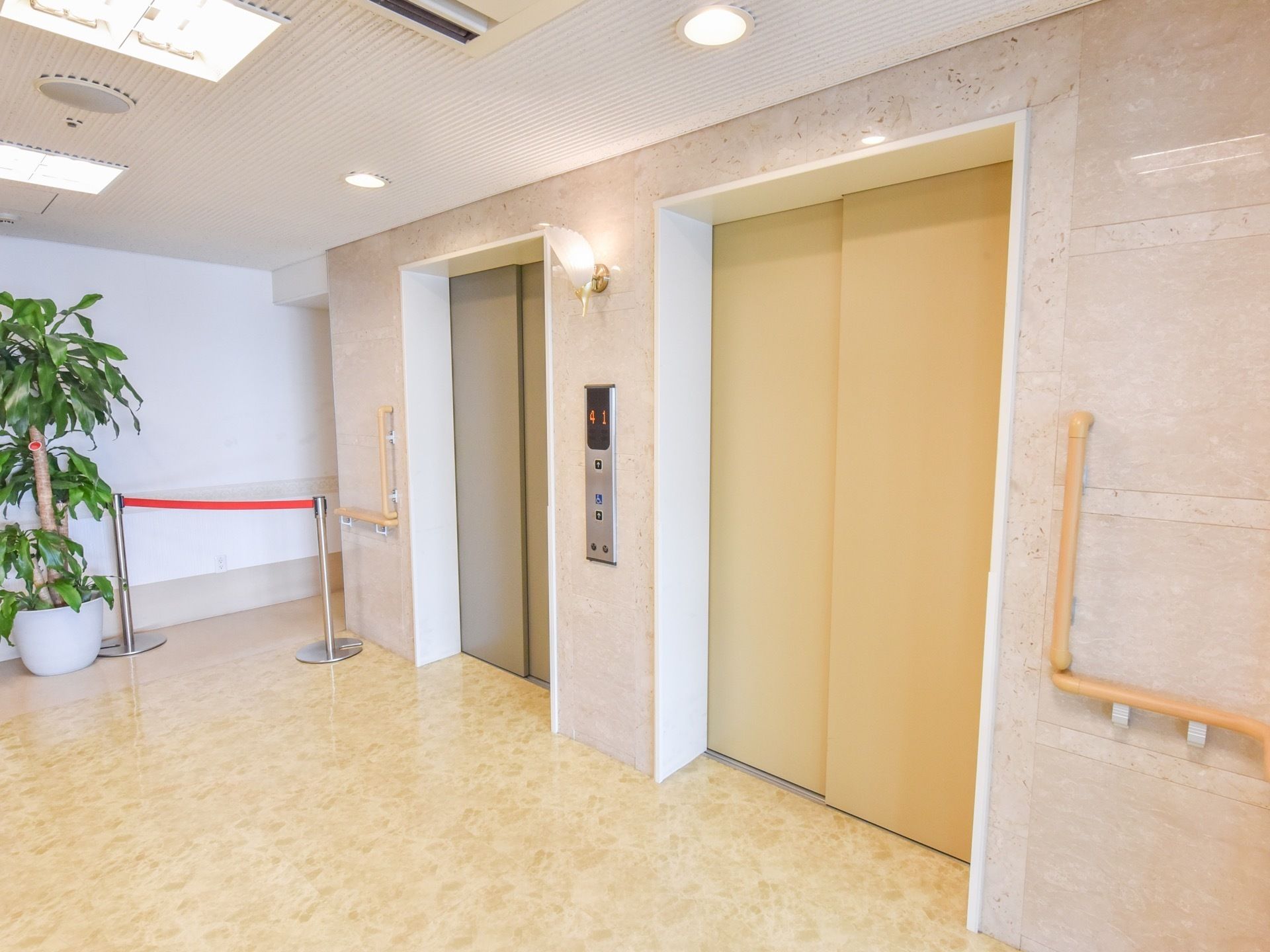施設内には、バリアフリーのエレベーターを完備している。壁には操作パネルがあり、手すりが取り付けられている。