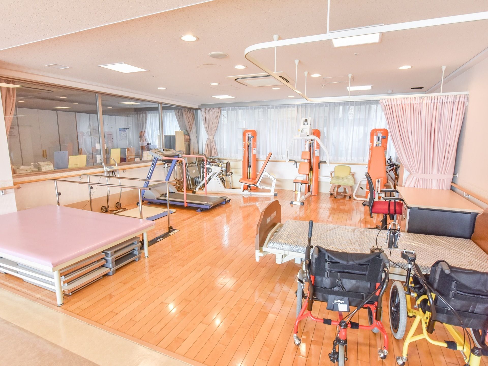 機能訓練室の天井には、スライドカーテンが取り付けられている。また奥にはガラス張りの、スタッフルームが併設されている。