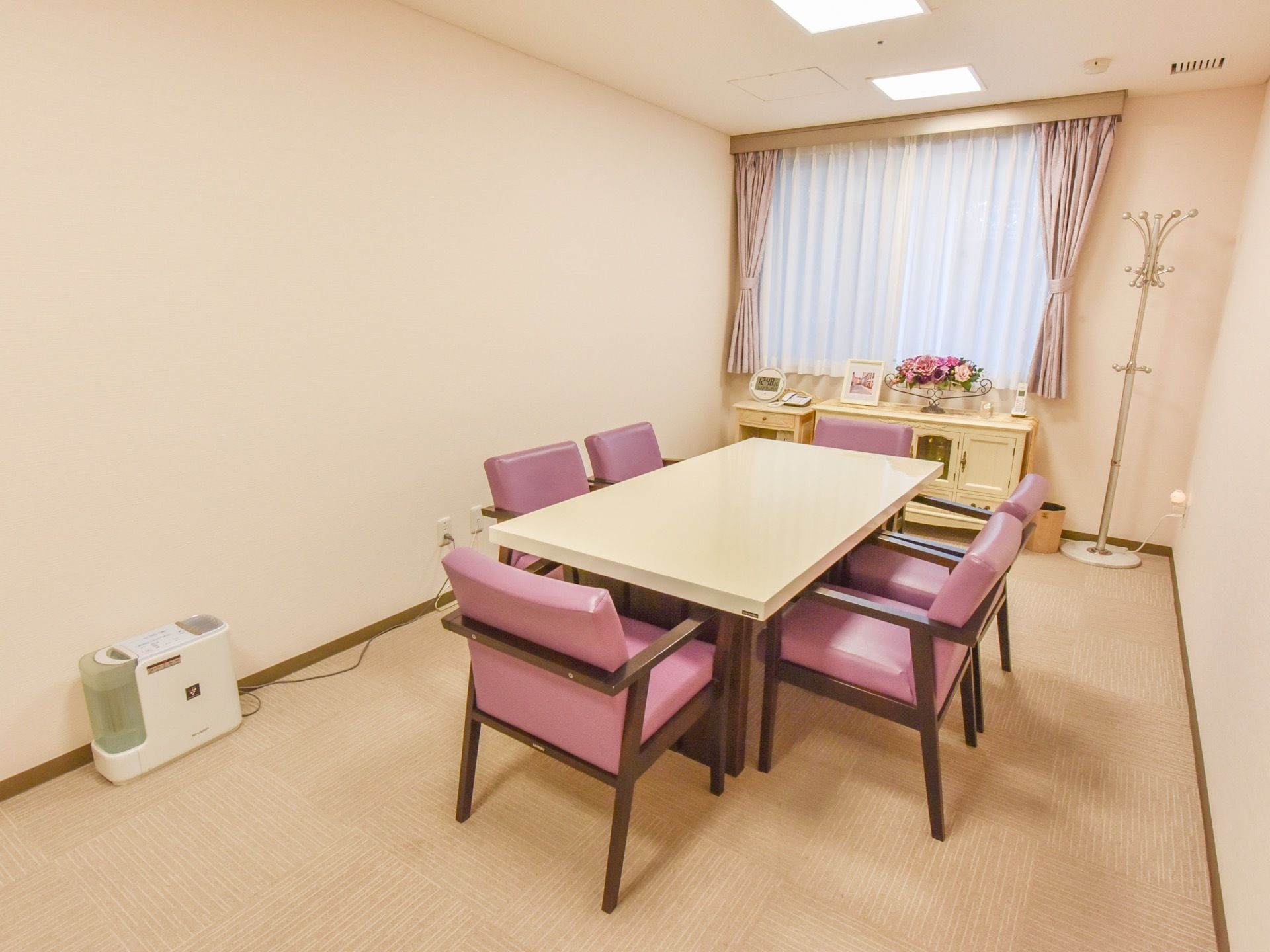 広々とした談話室には、テーブルと椅子が置かれている。また床にはコートスタンドがあり、加湿器を用意している。