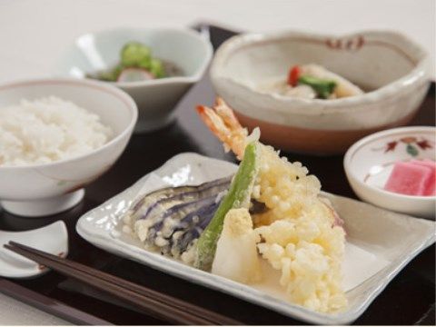 茶色のトレイに天ぷらの盛り合わせが乗せられている食事