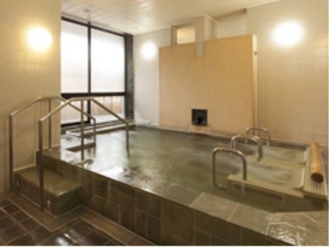 上がり口にプールのような手すりと階段の付いた浴槽があり、浴槽の右端にはジャグジーの装置が２つ並んでいる。