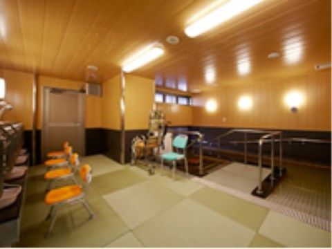 ４つのシャンプー台は鏡の両側に手すりがある。前には背もたれ付きの黄色いシャワー椅子が並んでおり、洗い場は畳敷きになっている。