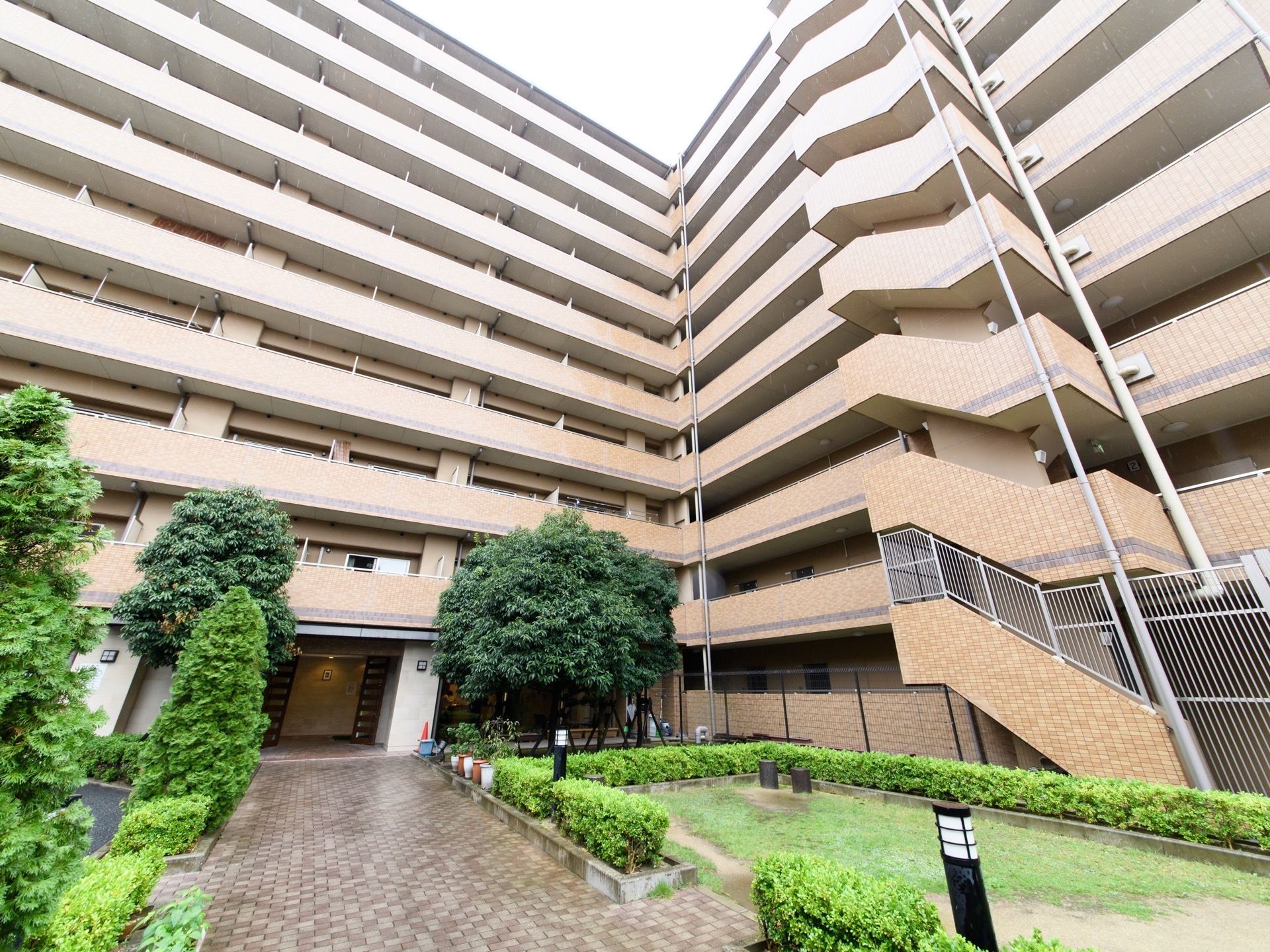施設の前にはたくさんの木々が植えられている。建物にはエレベーターだけではなく、階段が設置されており、緊急時には階段を使うことができる。