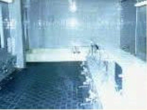 青を基調にした大浴場。広々とした空間にカランとシャワー、鏡がセットでいくつか並んでいる。銭湯感覚で利用していただける。
