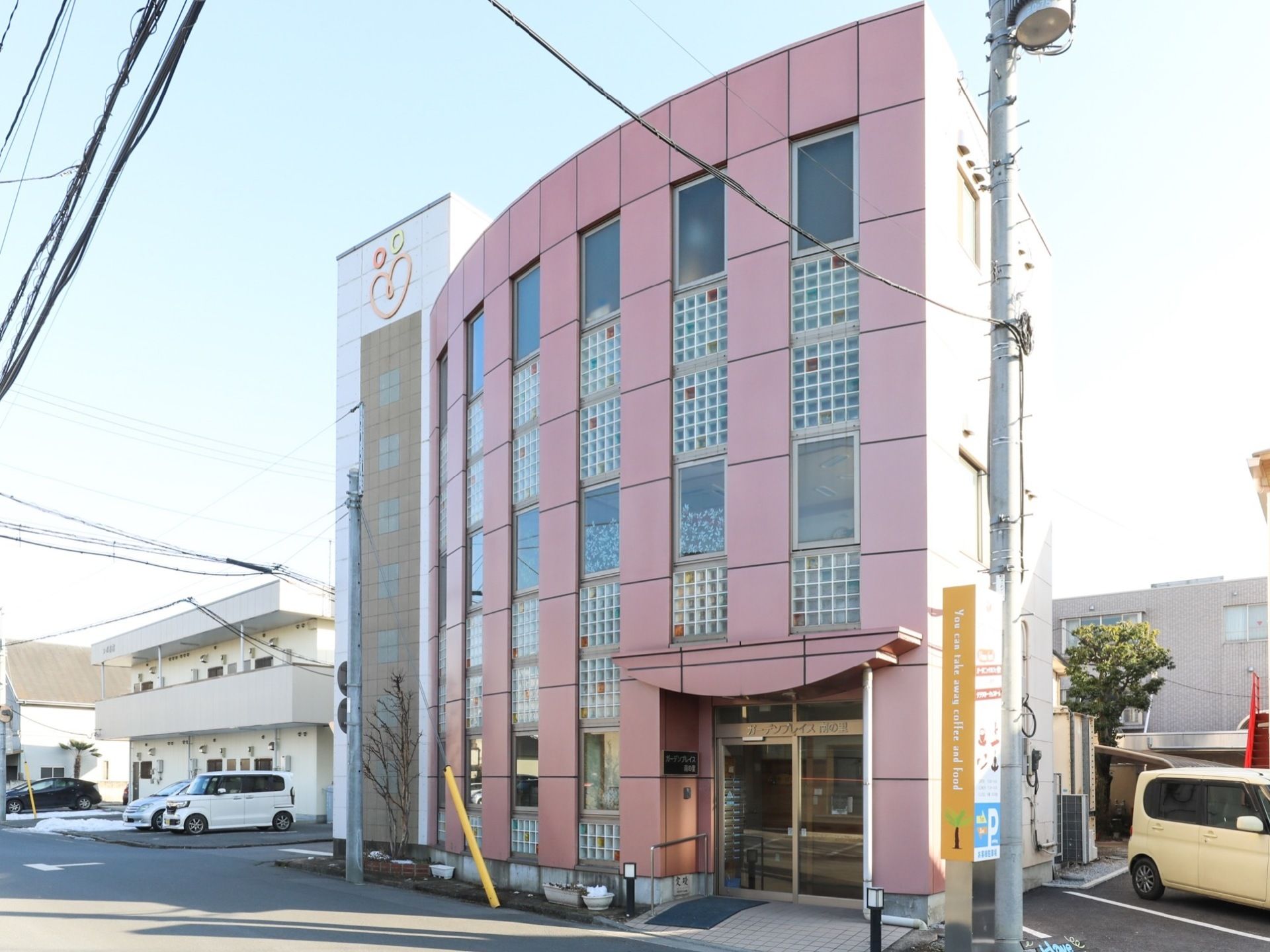 施設は薄いピンク色の分かりやすい3階建ての建物で、通りに面している。窓が多く設置されているので採光が確保されている。