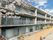 居室の窓周りの濃い青色を基調とした外壁が印象的な３階建ての施設