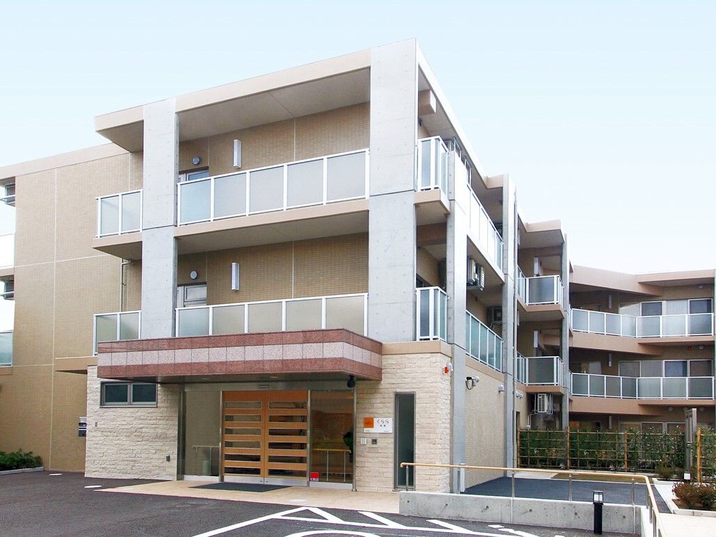 ベージュカラーが目に優しい、レンガ調の3階建ての施設