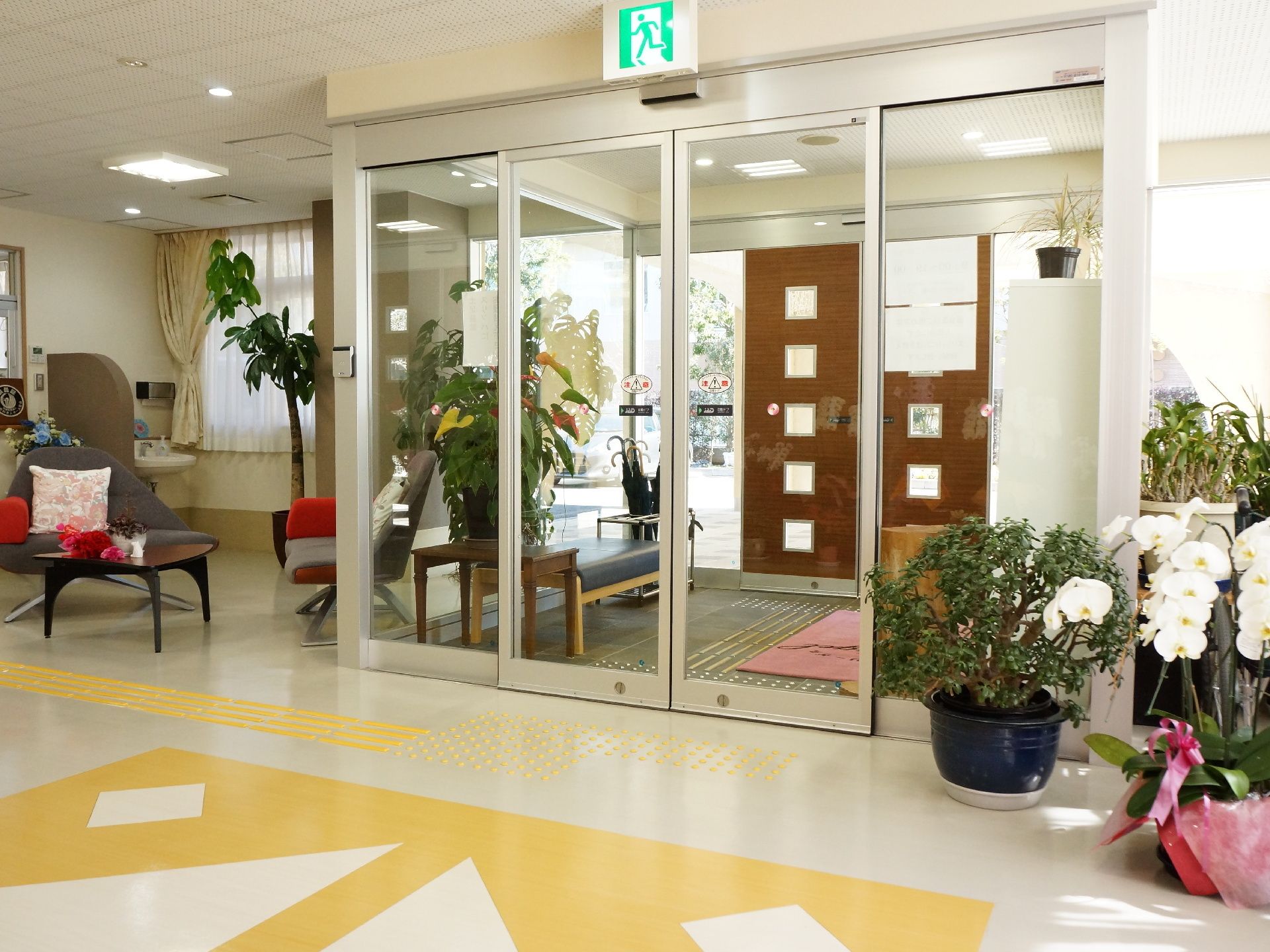明るく広い玄関フロアには、デザイン性の高い椅子や机が置かれている。靴の着脱がしやすい様に腰かけも置いてある。