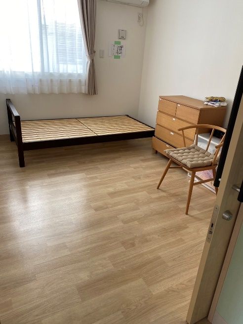 大きな窓が二つ付いた部屋には寝具付きのベッドや鏡台が置かれ、ベッドサイドにはライトもある。