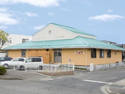 平屋建ての建物には大きな三角屋根が付き、駐車スペースも広い。