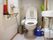 個室トイレの一例である。中央に温水洗浄便座付のトイレがある。右手の壁に流し台があり、左手には手すりがかかっている。