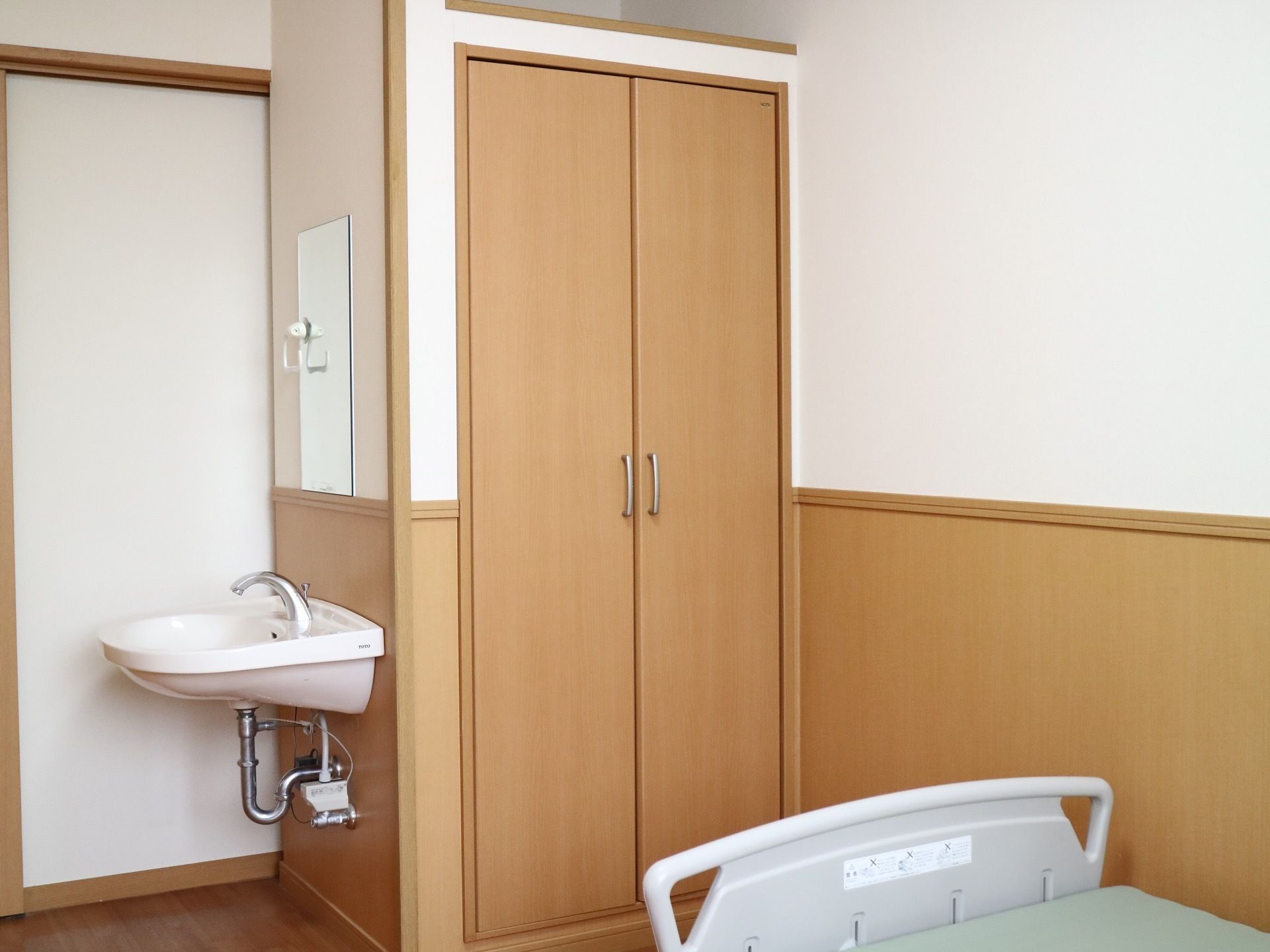 居室は角部屋で清潔感がある。クローゼットやベッドが常設されているほか、小型の洗面台も設けられている。