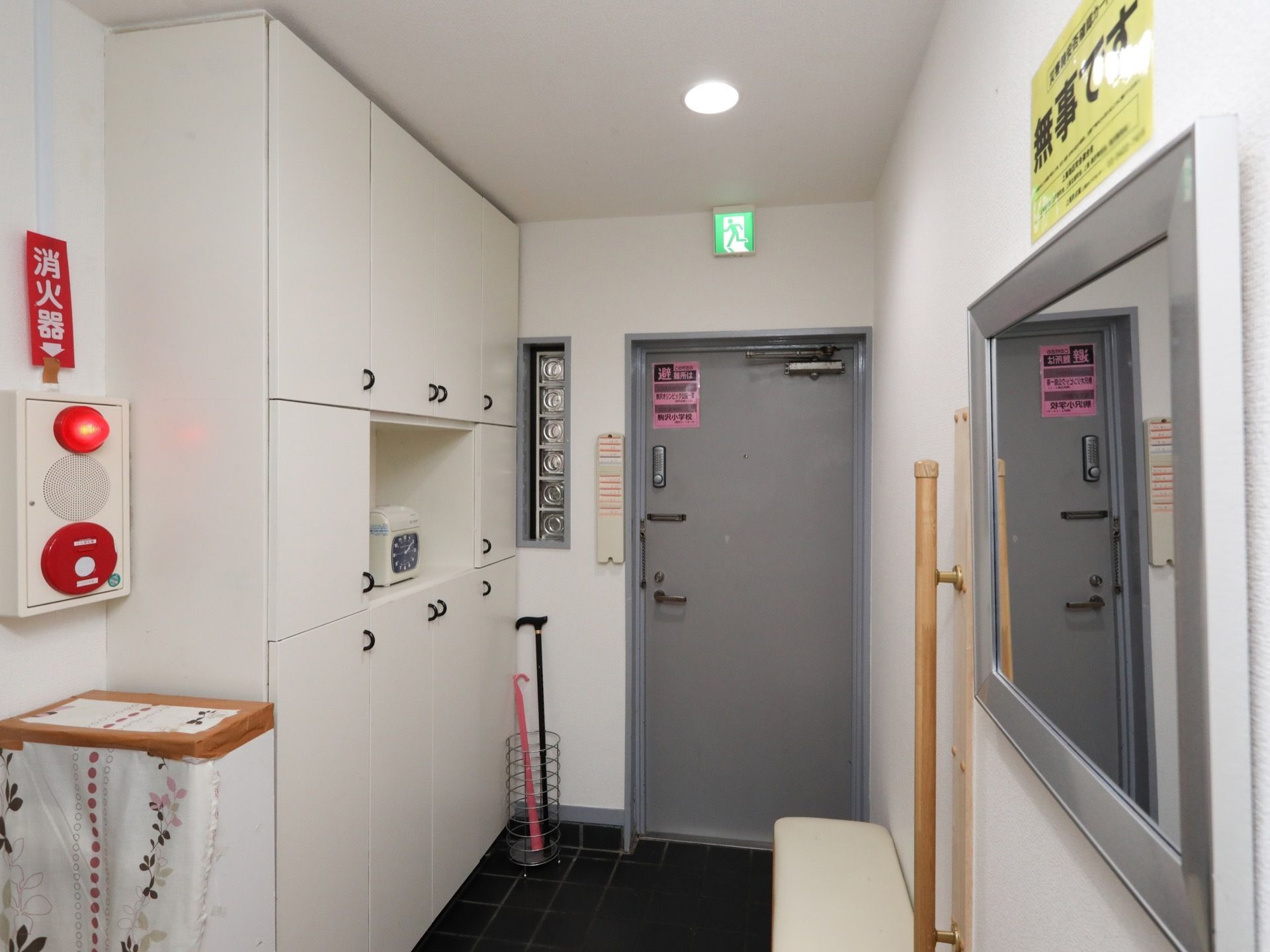 扉のそばには杖が置かれている。手前には大きな鏡が用意され、椅子に座りながら靴を履き替えることができる。