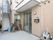 引違い扉の玄関である。扉横の壁には郵便受けと外灯が設置されている。また、入り口付近には水道も完備されている。