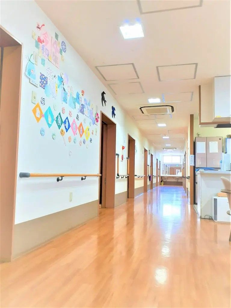 段差のない廊下。手すり付き、壁には色とりどりの飾りを飾っている。