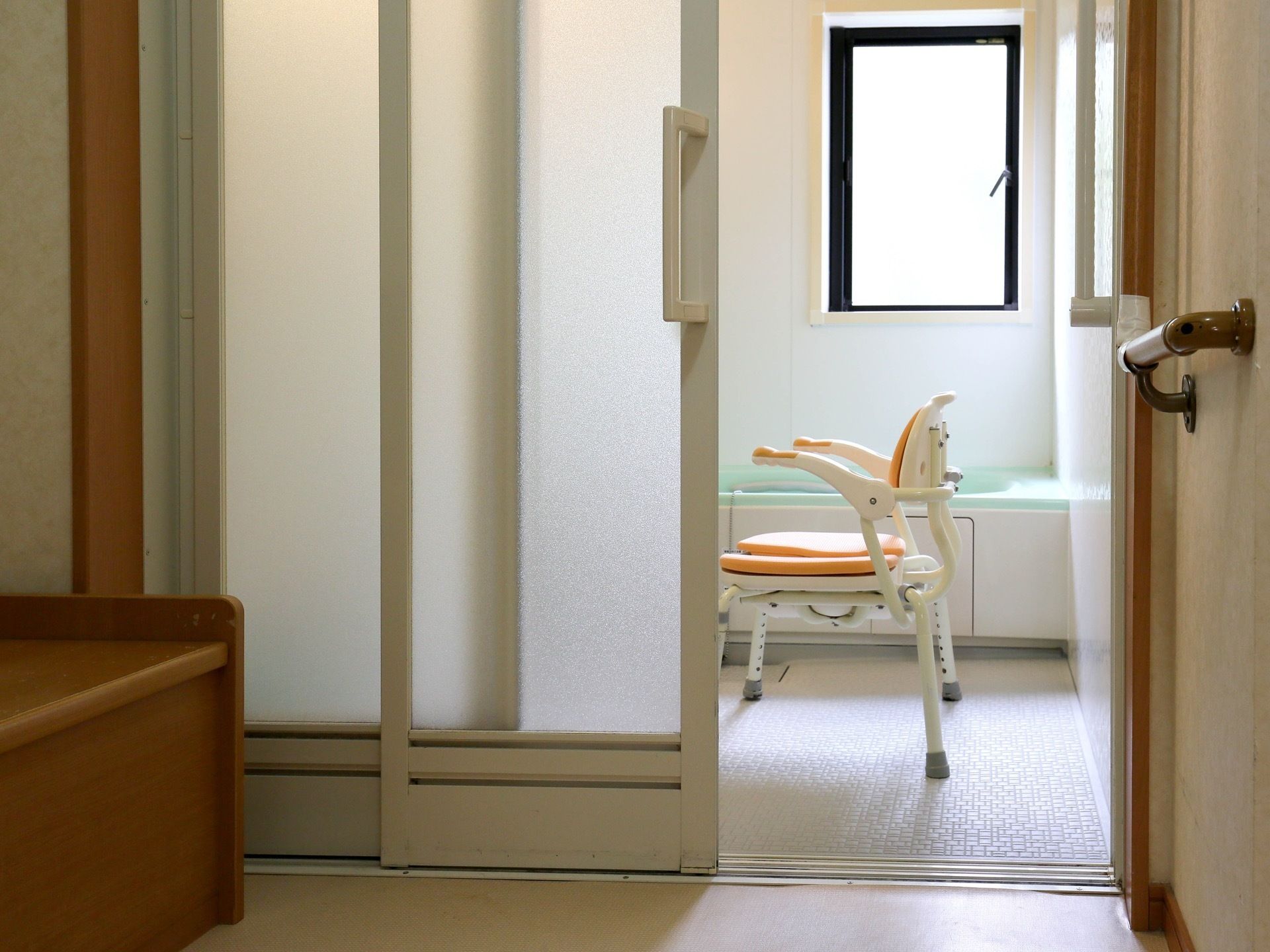 浴室には窓が設けられているので、日中は光がよく入り、明るい。窓を開けると風通しもよい。洗い場には椅子が置かれている。