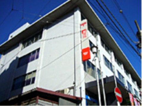 施設の近所には大きな郵便局があり、ハガキや切手の購入やATMの利用に便利。壁には、赤い看板が設置されている。