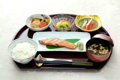 焼き鮭と野菜の煮物、ご飯と味噌汁にフルーツのデザートが付いたメニュー