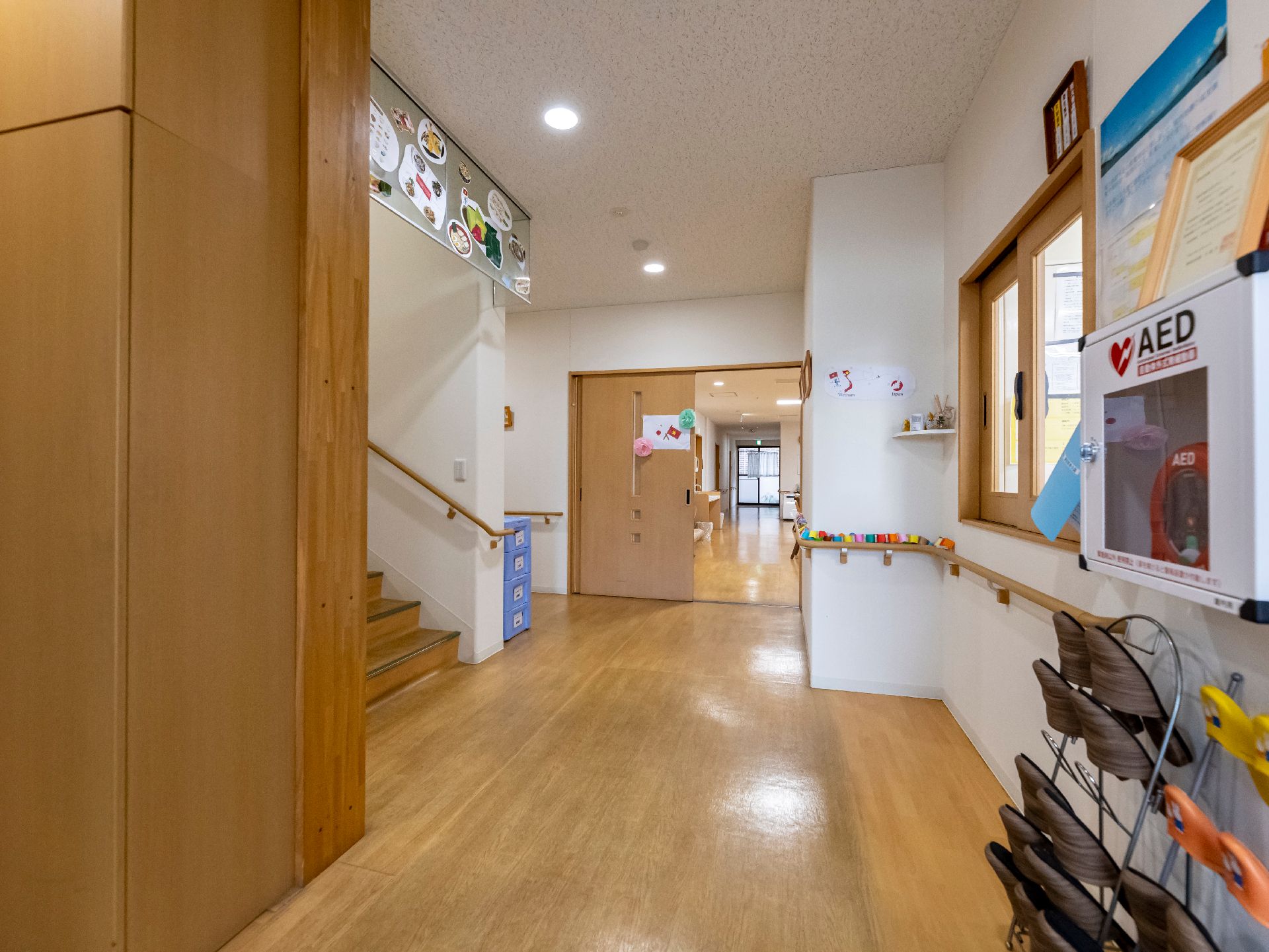 バリアフリー化されて段差がなく、壁に飾り物が展示されている廊下