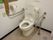 白が基調の明るいトイレは、温水洗浄便座なので、操作パネルにタッチするだけで簡単に利用できる。また、手すりが便器の両側に完備されている。