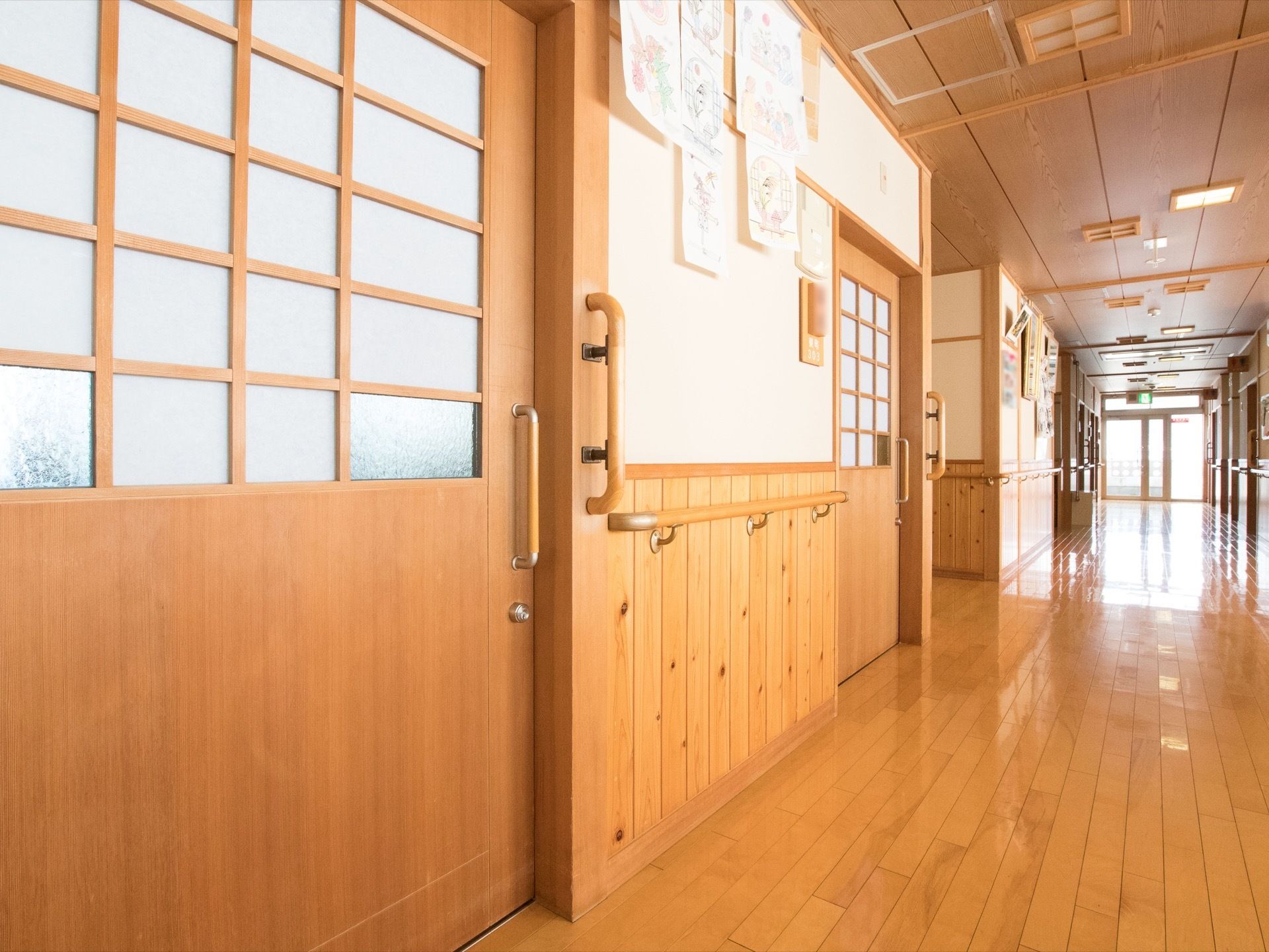床やドアは木材を使用して作られている。手すりも木材に合わせた色で統一されている。幅が広い廊下には、障害になるものが置かれていない。