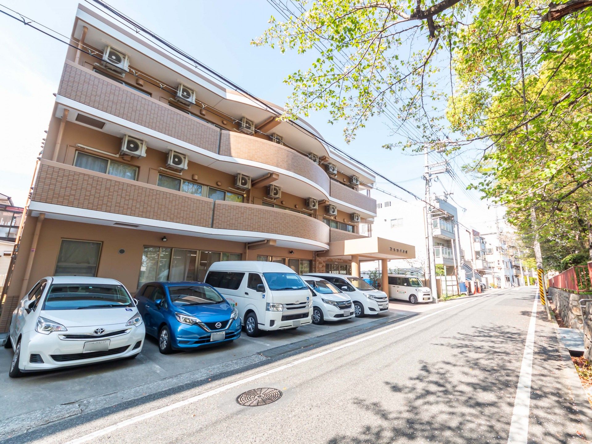 鏡を見ながら笑顔で話している高齢者とそこに寄り添介護スタッフの様子。明るい室内の写真