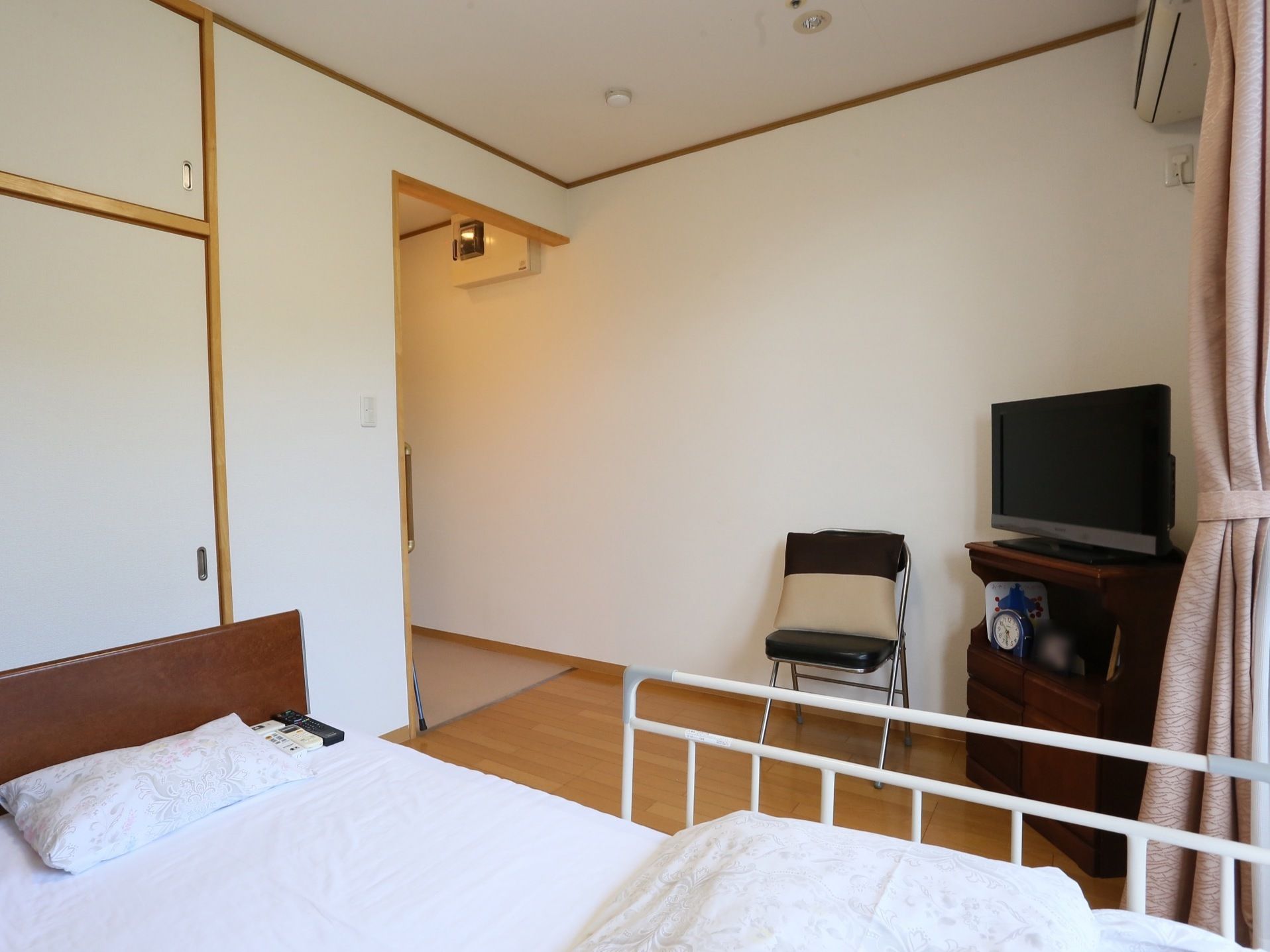 オフホワイトの壁と天井、床は木目調で明るく落ち着いた居室である。収納部分もたっぷりあり、有効に利用できる。