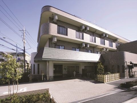 「ニチイホーム 三鷹」の外観。都会的なデザインの建物。