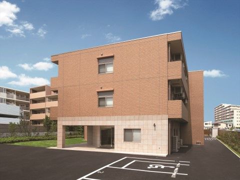 「ニチイホーム 西武柳沢」の外観。茶系の落ち着いたデザインの建物。