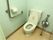 手すりがしっかりとついているので安全に使うことができる。洗浄機能などついていないトイレである。壁が水色で清潔感がある。