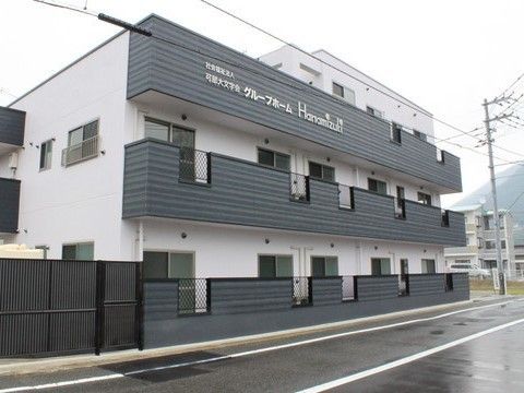 ツートンカラーが印象的な施設の外観。モダンなデザインのマンションのような施設
