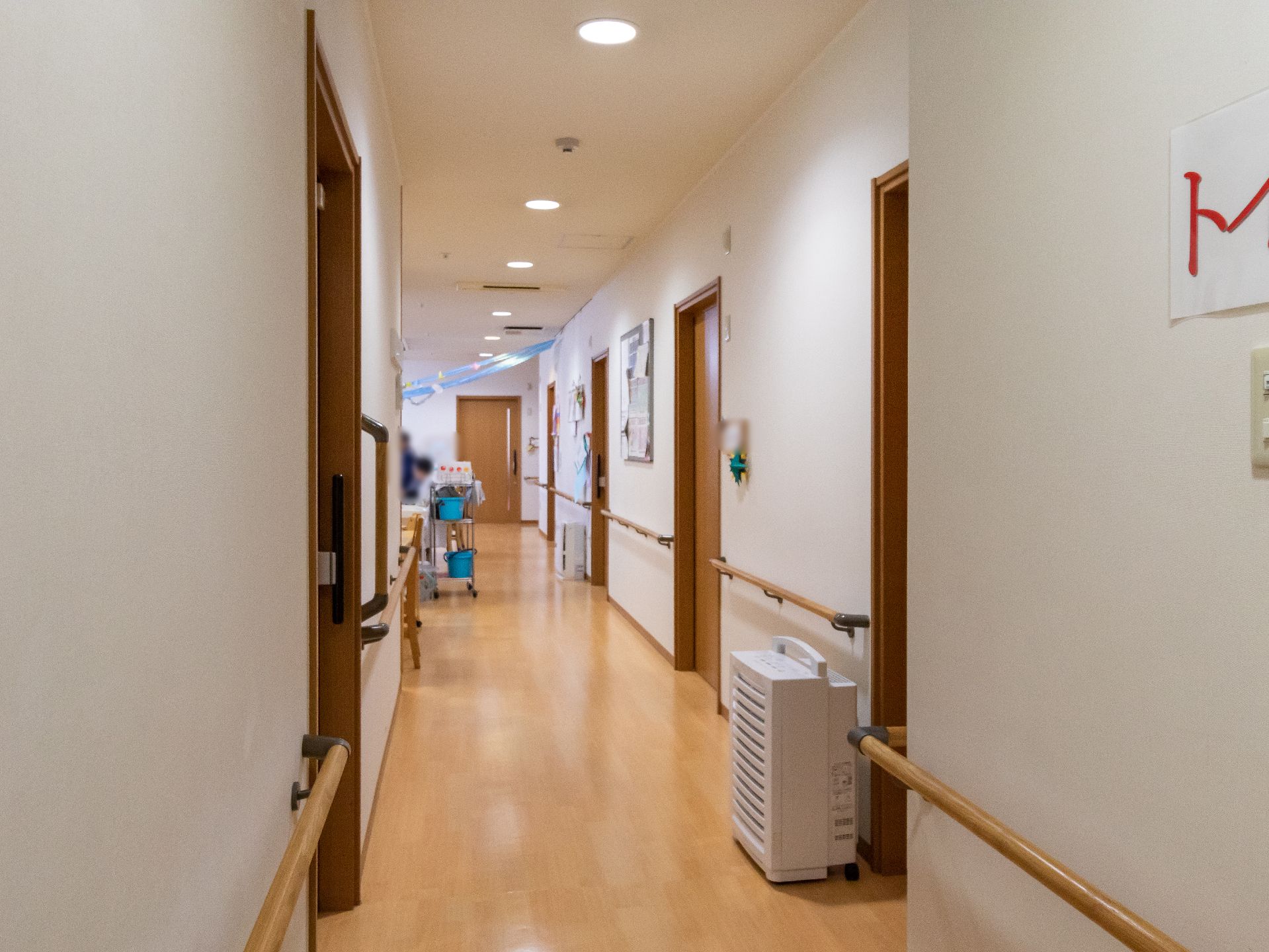 バリアフリー化されて手すりが行き渡り、空気清浄機が設置されている廊下