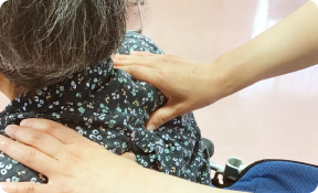 ケアの手がさりげなく支える様子