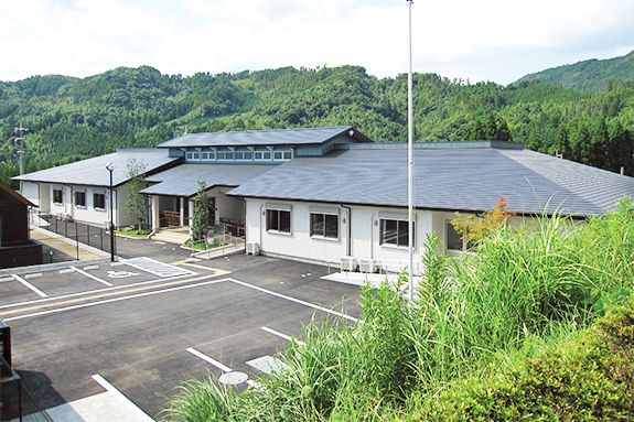 周囲を山に囲まれた場所に建つグループホームほしのさとの外観写真