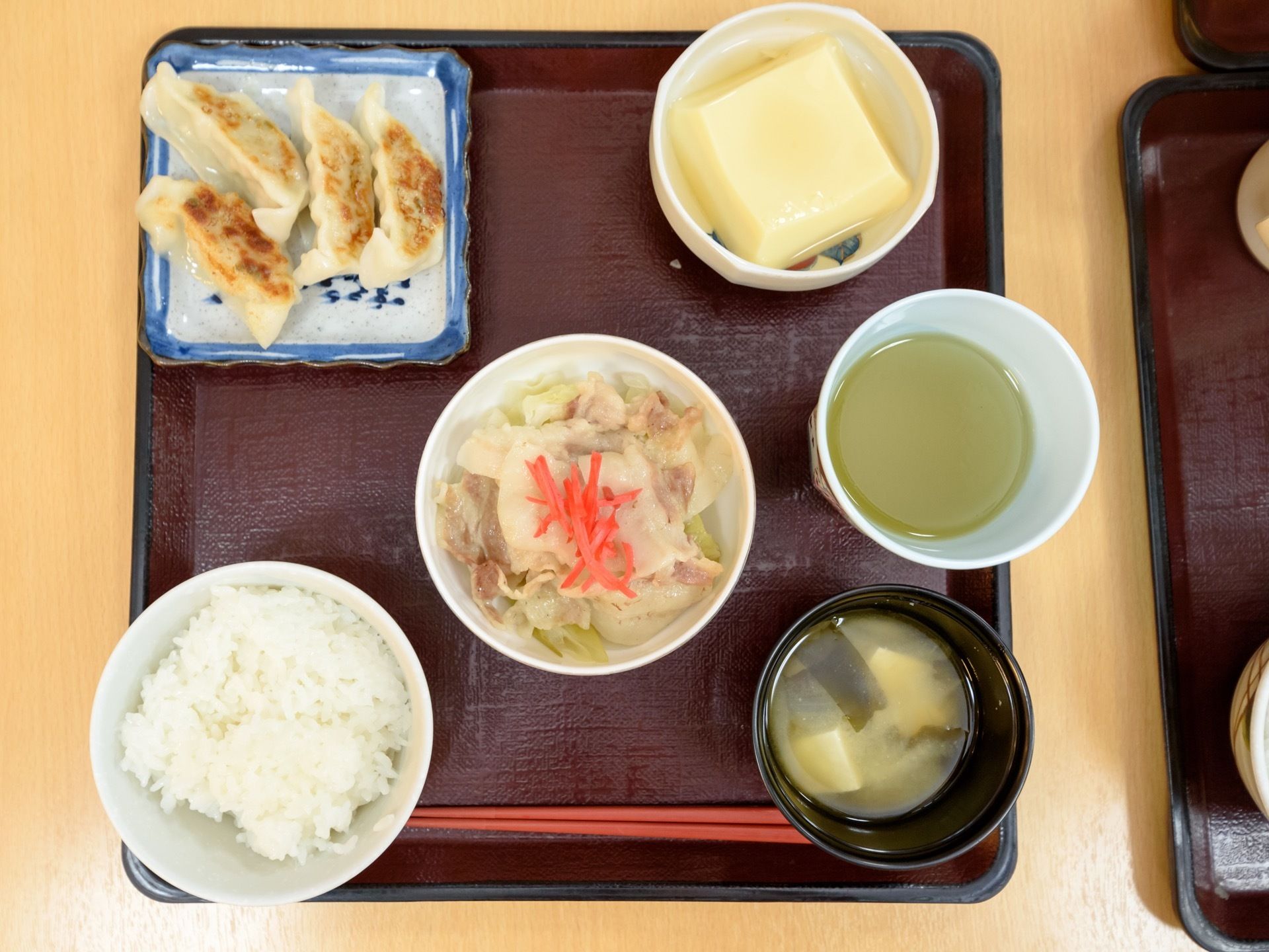 食事の一例。白米や味噌汁のほかに餃子や卵豆腐、その他肉類、野菜類を含んだ一汁三菜の形で配膳している。