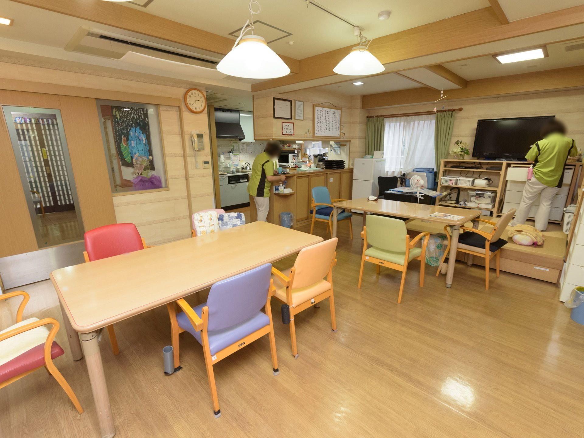 対面式キッチンが併設された食堂である。小上がりの和室スペースが設けられており、ダイニングテーブルが用意されている。